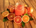 Bright composition with red oranges and fruit juice of fresh blood oranges