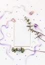 Bright composition with silk ribbons, eucalyptus, sequins and crystal on a white background. Space for a greeting text
