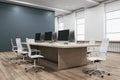 Bright concrete and wooden coworking office interior with furniture, equipment and window with daylight.