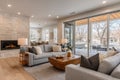 Modern Open-Concept Living Room with Stone Fireplace and Patio Doors Royalty Free Stock Photo