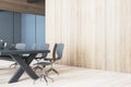 Bright contemporary meeting room interior with blank mock up place on wooden wall, table and chairs, decorative objetcs. 3D Royalty Free Stock Photo
