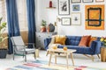 Bright and cozy living room interior with blue drapes, a sofa wi Royalty Free Stock Photo