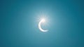 Bright crescent sun during a partial eclipse against a dark sky. Partial solar eclipse against a dim sky. Concept of Royalty Free Stock Photo