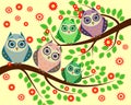 Bright cute cartoon owls sit on the flowering branches of trees