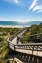Bright day view towards beach over looking wooden walk way Royalty Free Stock Photo