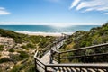 Bright day view towards beach over looking wooden walk way Royalty Free Stock Photo