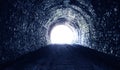 Bright daylight at the end of an old stone dark tunnel, the concept of going to another world Royalty Free Stock Photo