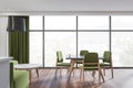 Bright dining room interior with green sofa, chair, panoramic window Royalty Free Stock Photo