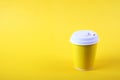 Colorful simplistic minimal composition with heat proof paper coffee cup. Take out tea mug with plastic cap. Coffee shop concept. Royalty Free Stock Photo