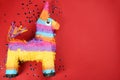 Bright donkey pinata and confetti on background, flat lay. Space for text Royalty Free Stock Photo