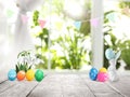 Bright Easter eggs, flowers and bunny figure on table Royalty Free Stock Photo