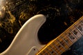 Bright electric guitar on a black-gold background close-up. Background. Wallpaper