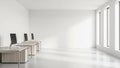 Bright Modern Empty Office Space With Rows of Desks and Computers Illuminated by Sunlight Through Tall Windows Royalty Free Stock Photo