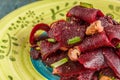 On a bright ethnic plate is a vegetarian lean beet salad, green