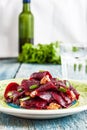 On a bright ethnic plate is a vegetarian lean beet salad, green