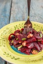 On a bright ethnic plate is a vegetarian lean beet salad, green