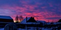 Bright evening red-pink winter sky over the countryside Royalty Free Stock Photo