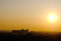 Bright evening sun over an abstract silhouette city.