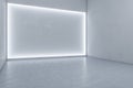 Bright exhibition hall interior with illuminated white mock up wall and concrete floor.