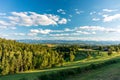 Podhale panorama - sunny rural landscape with rolling green hills, forest, farmhouses, and distant mountain range Royalty Free Stock Photo