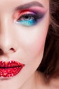 Bright eye makeup and red lips in rhinestones. Pink and blue color, colored eyeshadow. Royalty Free Stock Photo