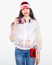 Bright fashionable portrait of a young woman in a trendy outfit with a vintage cassette player, headphones and camera. Royalty Free Stock Photo