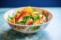 bright fattoush bowl with colorful bell peppers on top