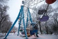 Bright ferris wheel in a snowy amusement park in winter Royalty Free Stock Photo