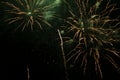 Bright fireworks with a green glowing center with green sparks and smoke, against the background of the night sky Royalty Free Stock Photo