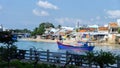 Bright fishing boats in the bay, Vietnam. blue boats with red details. Traditional Vietnamese buildings