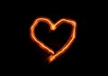 Bright flame burn heart symbol on black background in the dark, Valentine`s day or romantic concept background, copy