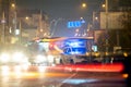 Bright flashing blue lights of police patrol car parked on city street with night traffic Royalty Free Stock Photo