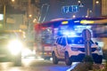 Bright flashing blue lights of police patrol car parked on city street with night traffic Royalty Free Stock Photo