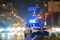 Bright flashing blue lights of police patrol car parked on city street with night traffic Royalty Free Stock Photo