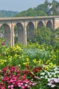 Bright Flowerbed and tall stone bridge