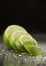 Bright fresh green limes on dark background