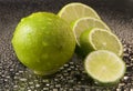 Bright fresh green limes on dark background