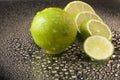 Bright fresh green limes on dark background