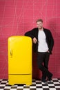 Bright fridge household appliances interior object. Designer adding accent to interior. Man lean retro vintage yellow