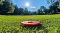 A bright frisbee lying on a well-maintained grassy field Royalty Free Stock Photo