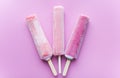 Bright fruit ice cream on a stick on a pink background. Frozen fruit ice. Summer mood. Cooling dessert in hot weather. Favorite de