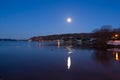 Bright full moon reflected in a St. Lawrence River cove during a blue hour dawn