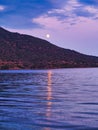 Full Moon Light Reflected in Sea Rising Over Treed Mountain Slope Royalty Free Stock Photo