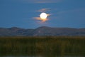 Bright full moon shining over Totora reeds on Lake Titicaca, Peru Royalty Free Stock Photo