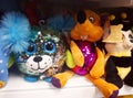 Bright and funny fashionable plush toys with sequins on a shelf of a children`s store Royalty Free Stock Photo