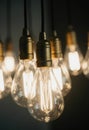 Bright garland light bulbs hang gracefully from the ceiling, casting a warm glow in a cozy indoor setting during the evening Royalty Free Stock Photo