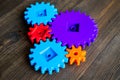 Bright gears for great technology of team work and correct mechanism on wooden background