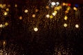 Bright glowing bokeh on wet glass against background of the nigh Royalty Free Stock Photo