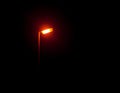 A bright glowing street lamp light in the dark outside at night Royalty Free Stock Photo