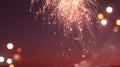 Bright golden fireworks exploding against a dark night sky with blurred lights in the background Royalty Free Stock Photo